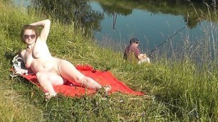 Wild beach. Sexy MILF Platinum naked sunbathing on river bank, random fisherman guy watches. Naked in public. Nude beach